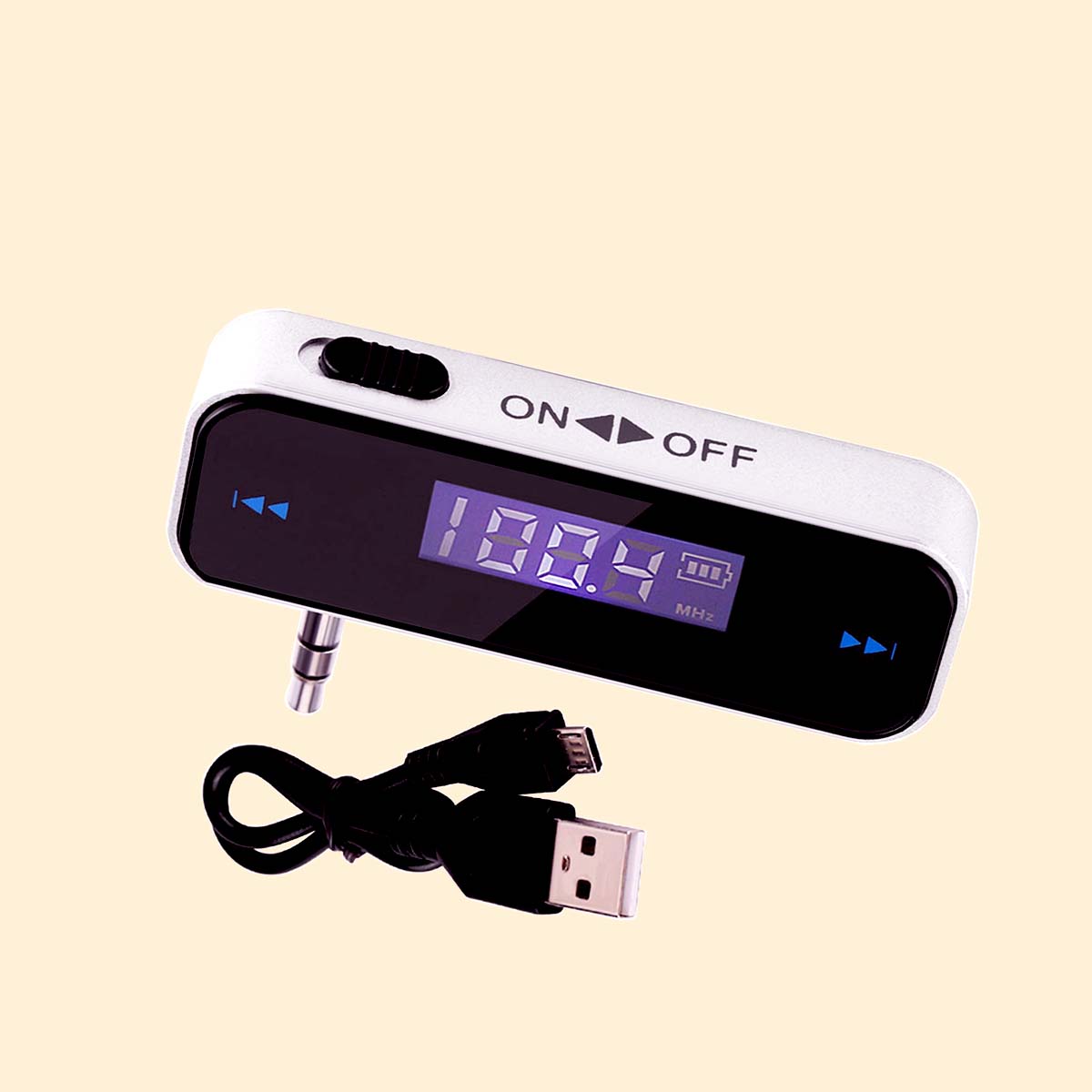 FM transmitter. Audio jack connection, an on off slide switch and frequency adjustment buttons are visible. as is an lcd screen displaying the current frequency range in MHz and the battery level. Also pictured is the charging cable